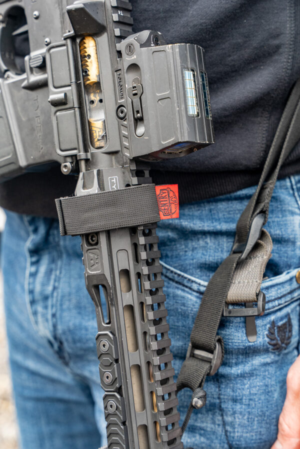 Black sentry strap with red tag on black ar-15.