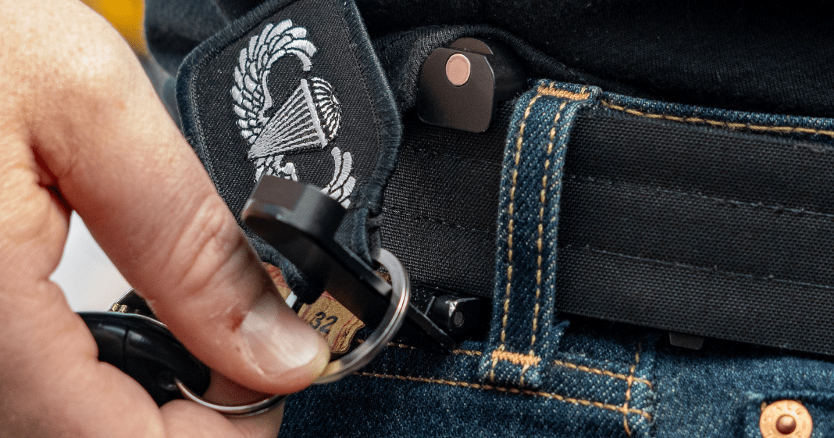 A man using a Tac-Trap by Neo Mag to attach keys to his belt for EDC.