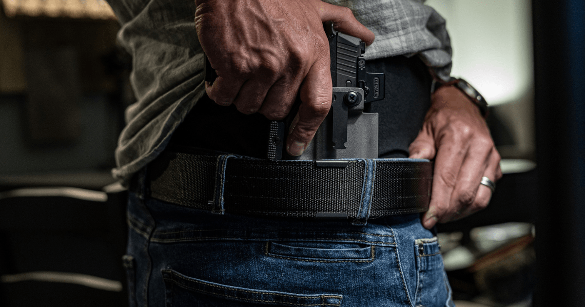 A man using an IWB holster with his Alias Belt Sytstem by NeoMag.