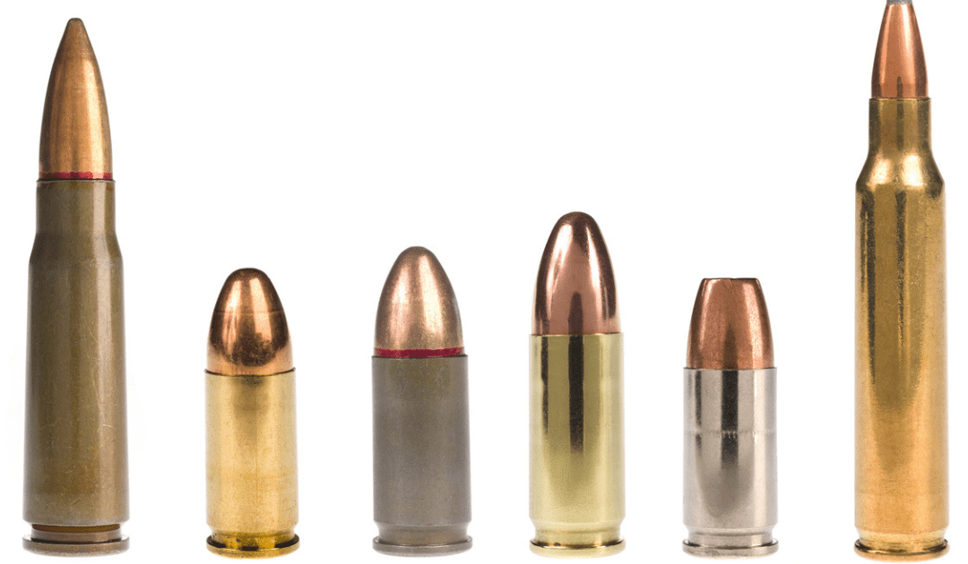 A row of different caliber bullets against a white background.