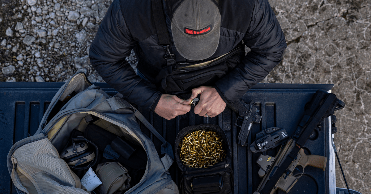 A man putting bullets in to a magazine.