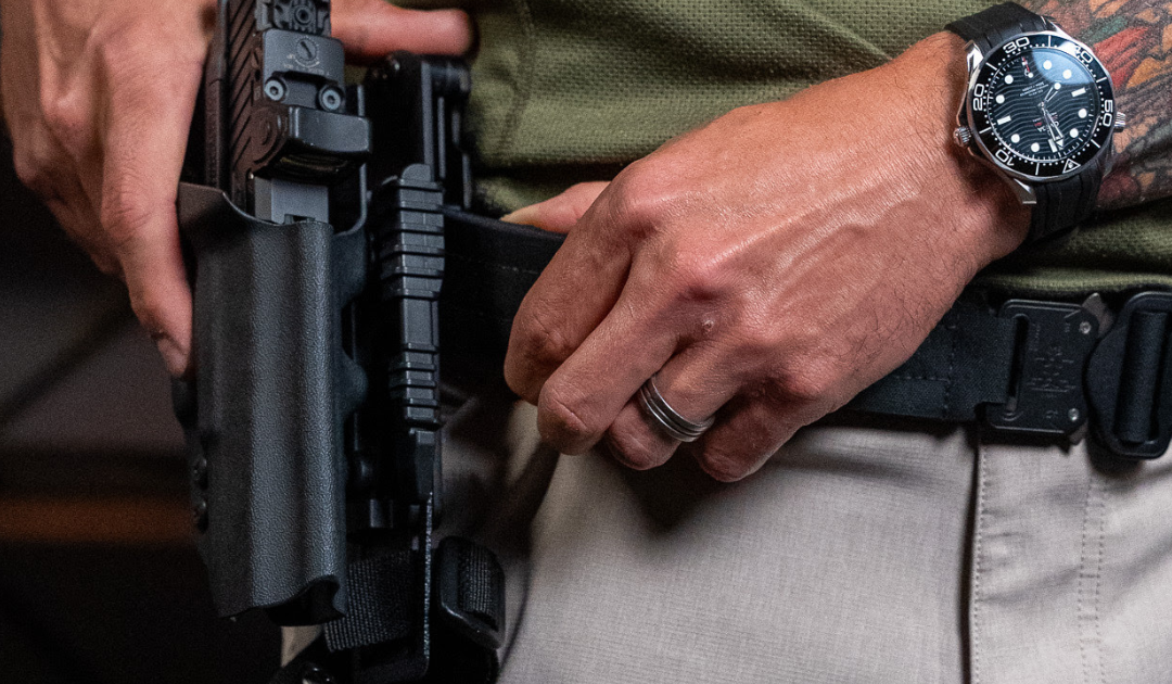 A man wearing his Alias Belt System for his OWB carry holster.