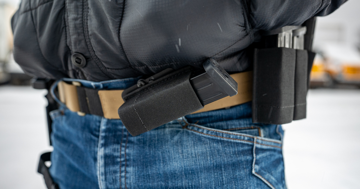 A spare magazine attached to a shooting belt using an Alias OWB Horizontal MOLLE Adapter.