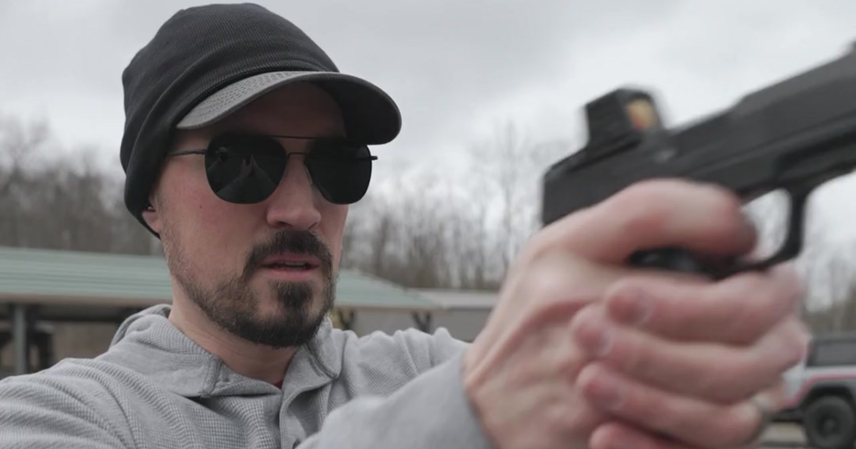 A man shooting his gun at EDC training.